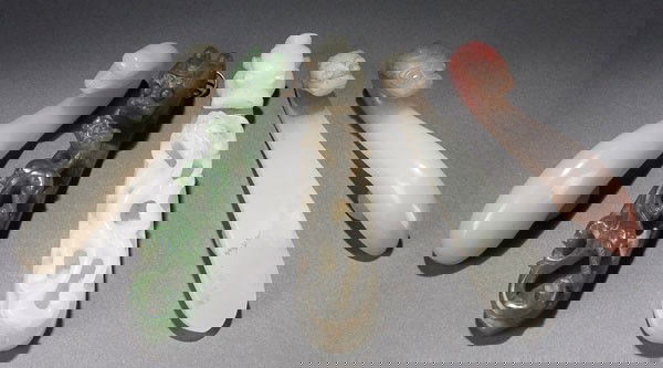 4 ORIENTAL JADE BELT HOOKS: FOUR CHINESE CARVED JADE BELT HOOKS, LATE QING. Two carved with "Dragon and Dragonet" reticulated forms in white jade and spinach green jade, two carved white bowenite hook. Length 3.25 inches (8.4 cm