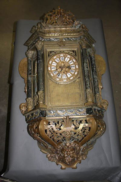 FRENCH BRONZE CHIME WALL CLOCK: A LARGE AND IMPRESSIVE NAPOLEON III BRONZE AND MARBLE CHIMING WALL CLOCK last quarter 19th century. The bronze movement with West Minster chimes contained in portico shape case flanked by a standing f