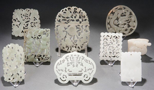 9 ORIENTAL JADE ORNAMENTS & PENDANTS: NINE CHINESE CARVED WHITE JADE ORNAMENT/PENDANTS 19th/20th century. Each carved and reticulated depicting various motifs including boys and fungus, dragons, bats and florals including a 2-piece interl
