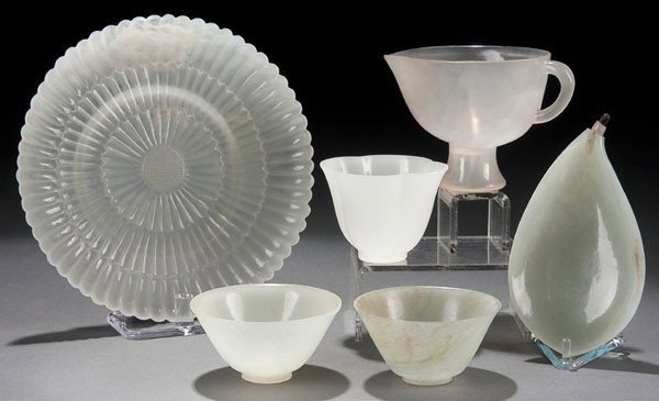 6 ORIENTAL JADE CONTAINERS: SIX CHINESE CARVED WHITE JADE CONTAINERS probably 20th century. Consisting of a Mughal style 'chrysanthemum' plate with fluted petals (diameter 5 inches), a leaf-form tray and four miniature cups/bowl