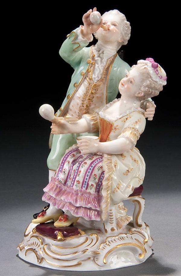 MEISSEN PORCELAIN FIGURE: A MEISSEN PORCELAIN GROUP 19th century. Of a couple blowing bubbles. Blue crossed swords and incised 122. Height 5.25 inches (13.5 cm).