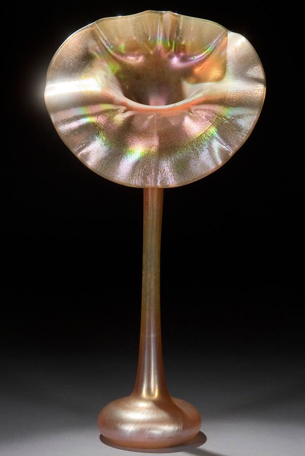 L.C. TIFFANY FAVRILE GLASS VASE: A LARGE L.C. TIFFANY GOLD FAVRILE GLASS JACK-IN-THE-PULPIT VASE early 20th century. With broad ruffled rim above a slender neck and cushion base, in gold colored glass with iridized highlights under a