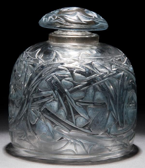 RENE LALIQUE EPINES GLASS COLOGNE BOTTLE: A RENE LALIQUE MOLDED, FROSTED AND PATINATED "EPINES" GLASS COLOGNE BOTTLE introduced 1920, Marcilhac 592 (Falcon no.3) with stylized thistle decoration. Embossed "R. Lalique France". Height 3.75 inch