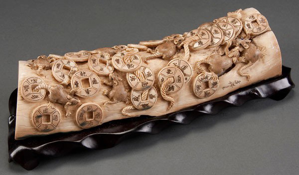 ORIENTAL CARVED MAMMOTH IVORY TUSK: A CHINESE CARVED MAMMOTH IVORY TUSK 20th century. Decorated with 11 figural rats and 26 coins. Length 9.75 inches (24.5 cm).