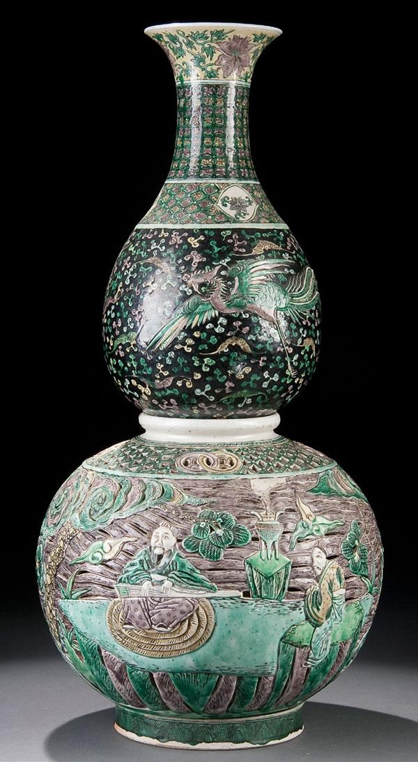 ORIENTAL FAMILLE NOIR DOUBLE GOURD VASE: A CHINESE FAMILLE NOIR DOUBLE GOURD RETICULATED VASE 19th century. Constructed in three parts, the baluster form vase enameled with bats on a black ground, applied to an internal liner/support within 
