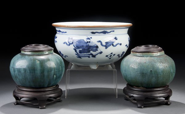 A CHINESE BLUE/WHITE PORCELAIN JARDINIERE: A CHINESE BLUE/WHITE PORCELAIN JARDINIERE 19th century, with tea glazed rim and Buddhist symbols. Diameter 8.5 inches. Together with a pair of Foochow turquoise glazed jars raised on wooden stands. Di