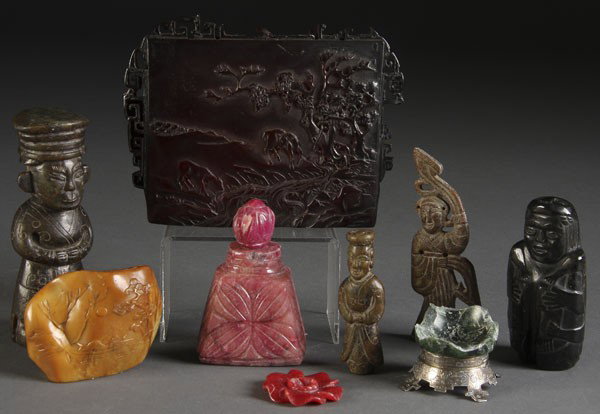 CHINESE CARVED DECORATIVE ARTS GROUP: A CHINESE CARVED DECORATIVE ARTS GROUP consisting of a pair of carved brown and black jade deities, a small soapstone mountain, a rose quartz bottle, a sterling footed jade fragment and a large carved