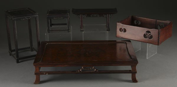 5 CHINESE CARVED ROSEWOOD DISPLAY STANDS: A GROUP OF 5 CHINESE CARVED ROSEWOOD DISPLAY STANDS. Of miniature furniture form, consisting of an 18 inch x 12 inch low table with burled top, a 4 inch tall altar, a 4 inch tall stand, a 9 inch tall 