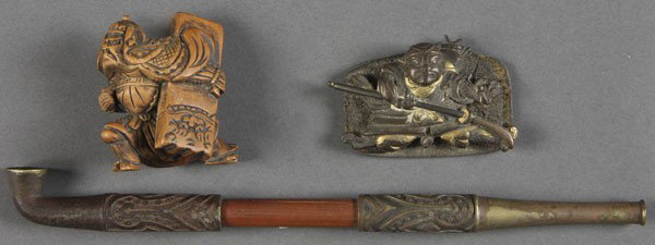 3 PC JAPANESE DECORATIVE ARTS GROUP: A THREE PIECE JAPANESE DECORATIVE ARTS GROUP consisting of a late Edo/early Meiji period silver and gilt bronze manuki of a seated samurai, a carved boxwood netsuke and a bronze and iron pipe with emb