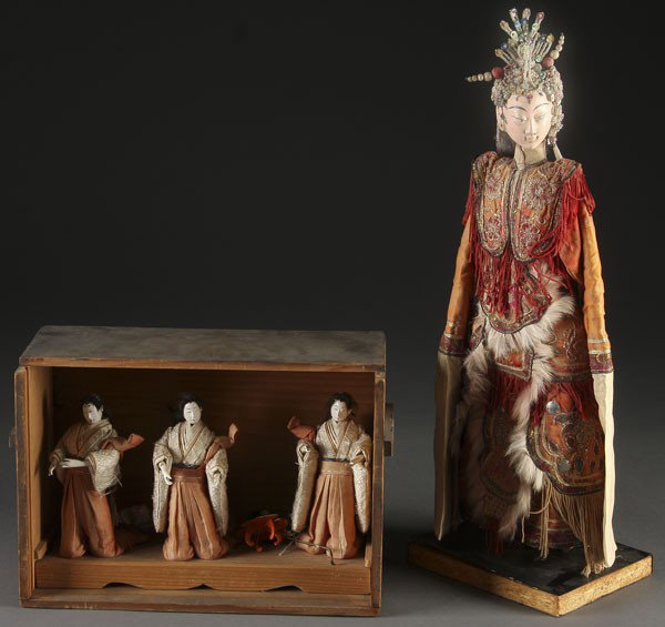 CHINESE PUPPET DOLL: AN CHINESE PUPPET DOLL early 20th century. Of a Mio Minority woman with carved and painted facial features, glass beaded headdress and fur-trimmed and embroidered costume mounted on a later plinth. He