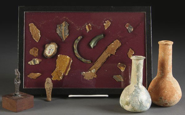 GROUP OF ANCIENT RELICS: A GROUP OF ANCIENT RELICS including a 1st Century Egyptian perfume bottle in light blue glass (height 4.75 inches), an probably Egyptian statue of Osiris (height 2.5 inches), an Egyptian figure pendan