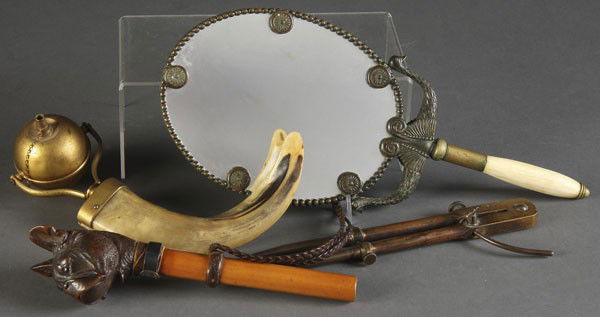 EUROPEAN DECORATIVE ARTS GROUP: A EUROPEAN DECORATIVE ARTS GROUP 4 pieces consisting of a 19th c. brass starrett dividers, an Egyptian revival ivory handled bronze hand mirror, a horn handled oil lamp and a carved animated dog's hea
