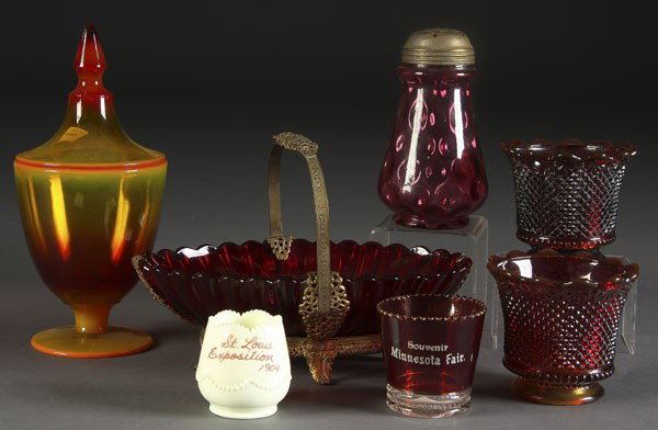 7 PC VINTAGE COLORED GLASSWARE GROUP: A 7-PIECE VINTAGE COLORED GLASSWARE GROUP late 19th/early 20th century. Consisting of a Cambridge Sunset covered candy, a cranberry thumbprint muffineer, an Amberina ormolu mounted basket, St. Louis a