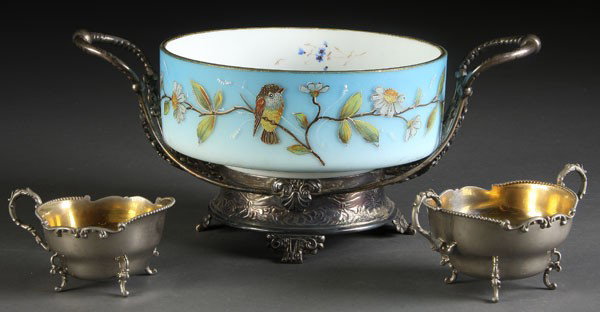 VICTORIAN ENAMELED GLASS BRIDES BOWL: A VERY FINE VICTORIAN ENAMELED GLASS BRIDES BOWL in Pairpoint silvered frame decorated with birds on a branch. Together with a silverplate cream and sugar. Length 14 inches.