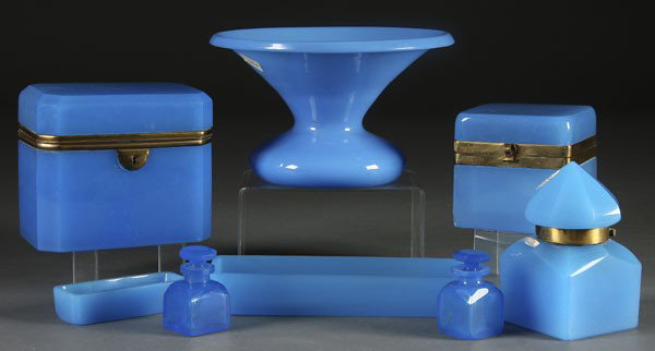 8 PC GROUP OF BLUE OPALINE GLASS: AN 8-PIECE GROUP OF BLUE OPALINE GLASS last quarter 19th century. Consisting of a spittoon, 2 lidded dresser boxes, an inkwell, 2 matching perfumes and 2 trays. Height 5.25 inches.