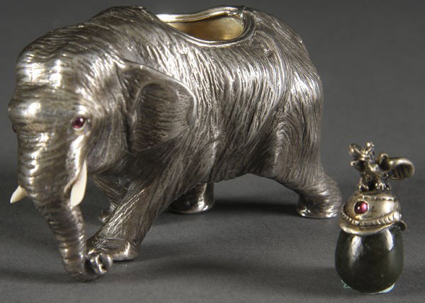 RUSSIAN SILVER ELEPHANT: A RUSSIAN SILVER ELEPHANT in the Faberge style. With carved ivory tusks, ruby eyes and partially hollowed gilt interior. Hallmarked 84 and spurrious maker's marks, length 3 inches. Together with a min