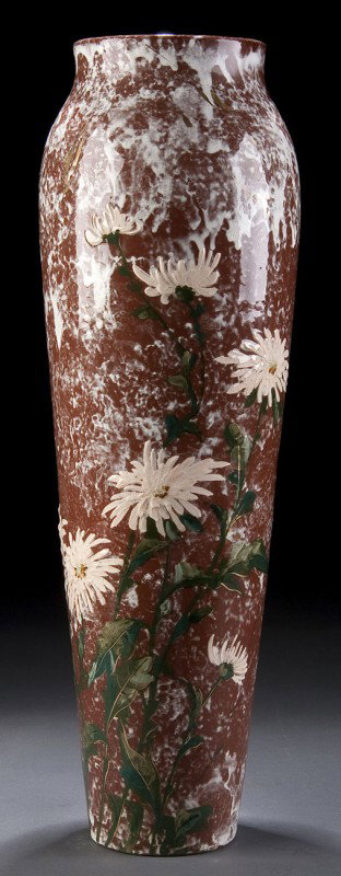 ROOKWOOD LIMOGES STYLE ART POTTERY VASE: A ROOKWOOD LIMOGES STYLE ART POTTERY VASE, circa 1883, with overglaze decoration by Matt Daly under a clear glaze on red ground, restorations, incised Rookwood name, date and artist signature. Height 