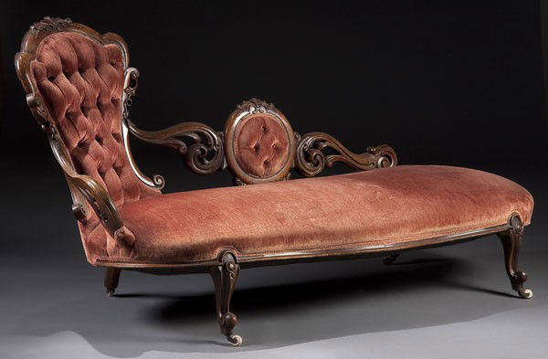 VICTORIAN WALNUT ROCOCO CARVED CHAISE LOUNGE: A VERY FINE VICTORIAN WALNUT ROCOCO CARVED CHAISE LOUNGE with pierced scrolling brackets supporting a waisted back with diamond tufting. 37 x 67 x 28 inches.