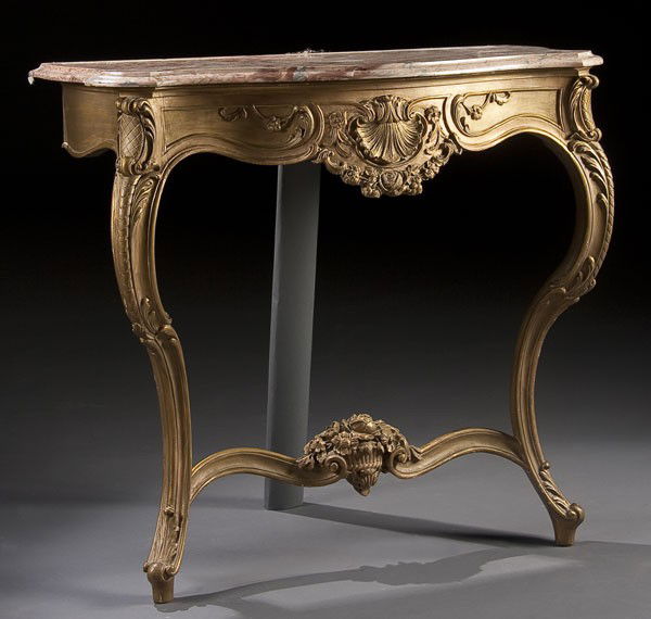LOUIS XVI STYLE MARBLE TOPPED CREDENZA: A LOUIS XVI STYLE GILT WOOD MARBLE TOPPED CREDENZA with carved acanthus and floral decoration raised on two cabriole legs below a rouge marble top. 32 x 31.5 x 15 inches.