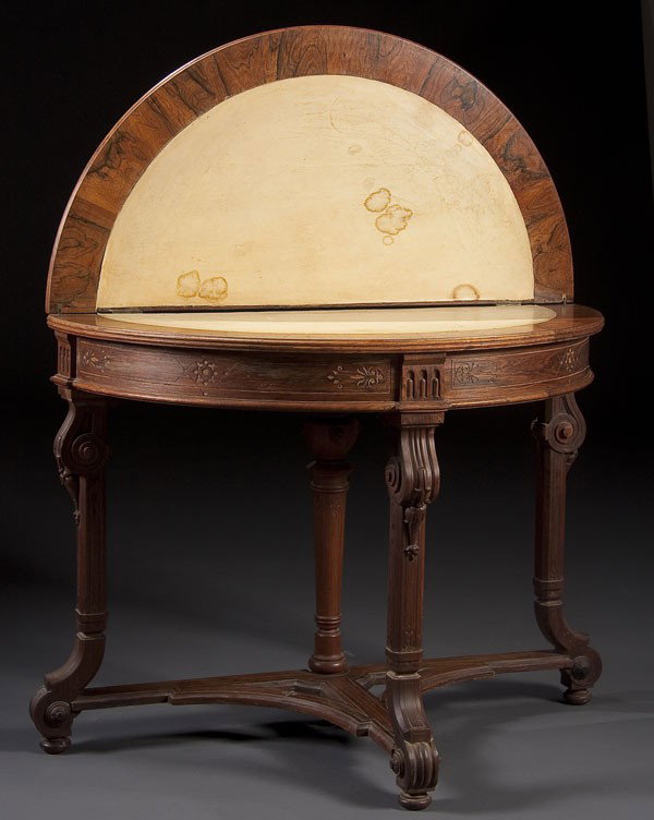 ROSEWOOD VICTORIAN AESTHETIC GAME TABLE: A ROSEWOOD VICTORIAN AESTHETIC GAME TABLE of demi-lune shape with folding top with inset kid leather panels above incised and fluted scrolled legs. 30 x 38 inches.