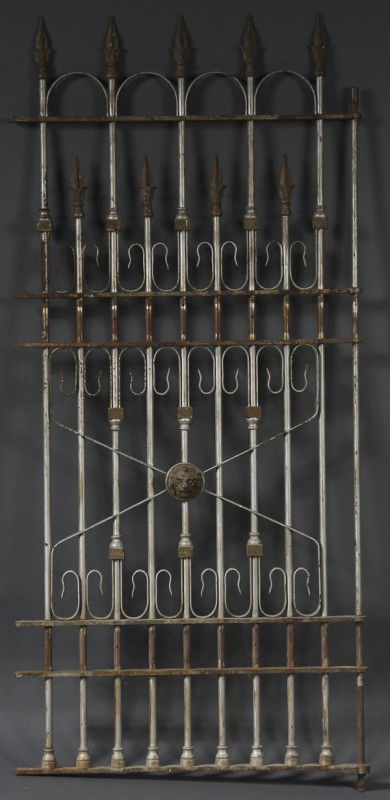 VICTORIAN WROUGHT IRON BANK VAULT GATE: A VICTORIAN WROUGHT IRON BANK VAULT GATE late 19th century. With 9 bars terminating in cast iron finials above an embossed cast lion's head mask. 67 x 31 inches.