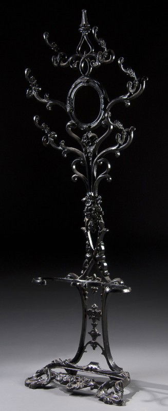 VICTORIAN CAST IRON HALL TREE: A VICTORIAN CAST IRON HALL TREE with embossed scrolled decoration and coat hooks for 6 garments. 74 x 26 x 11 inches.