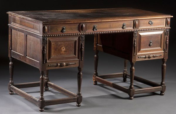 KITTINGER WALNUT PARTNER'S DESK: A KITTINGER WALNUT PARTNER'S DESK 1930's, with carved panels and drawers on opposite sides. 31 x 54.5 x 27.5 inches.