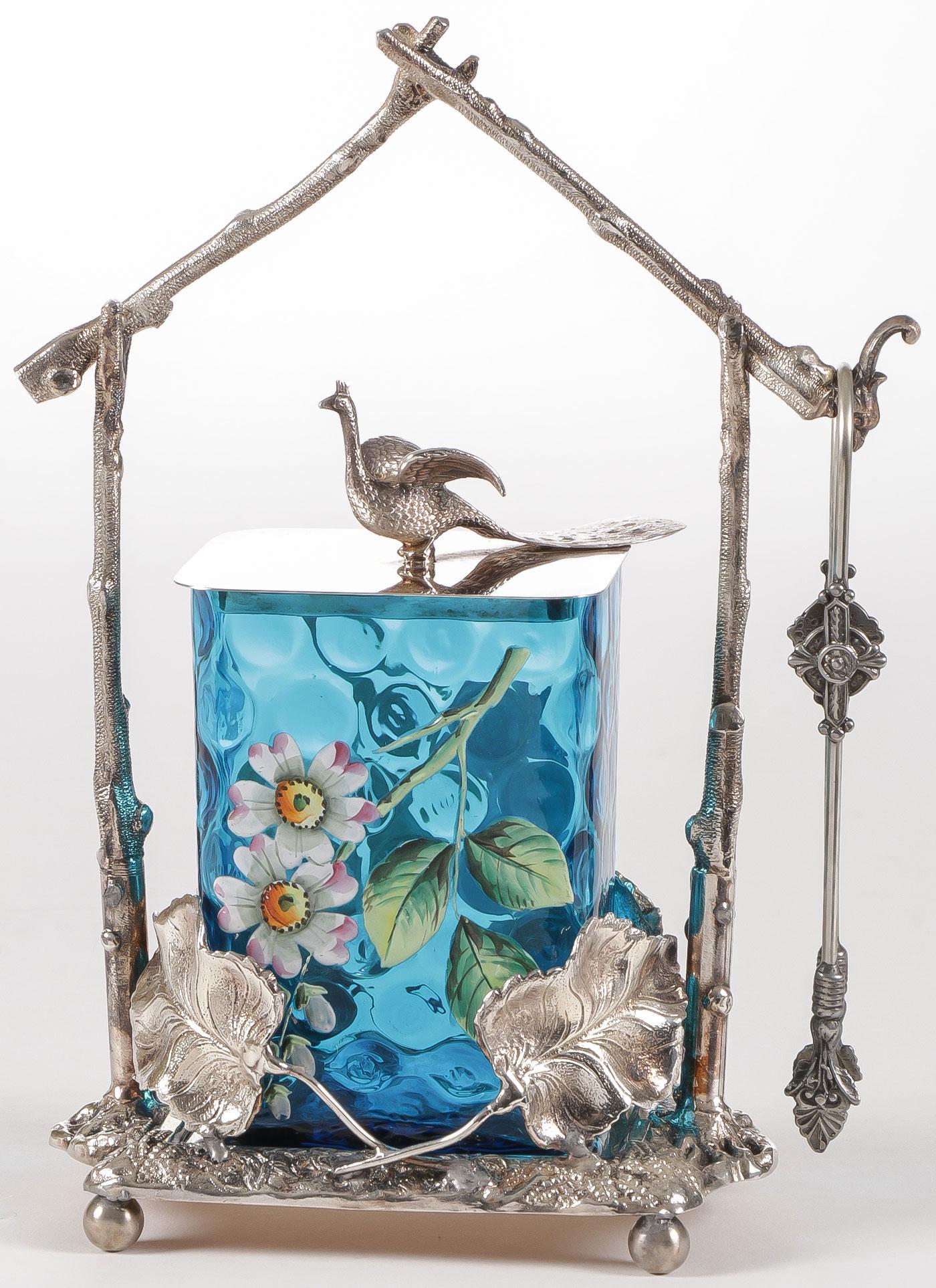 RARE & EXCEPTIONAL VICTORIAN PICKLE CASTOR: RARE & EXCEPTIONAL VICTORIAN PICKLE CASTOR. Comprising a large and ornate silver-plated frame holding a rectangular blue thumbprint insert with enameled flowers and fitted lid with peacock finial and 