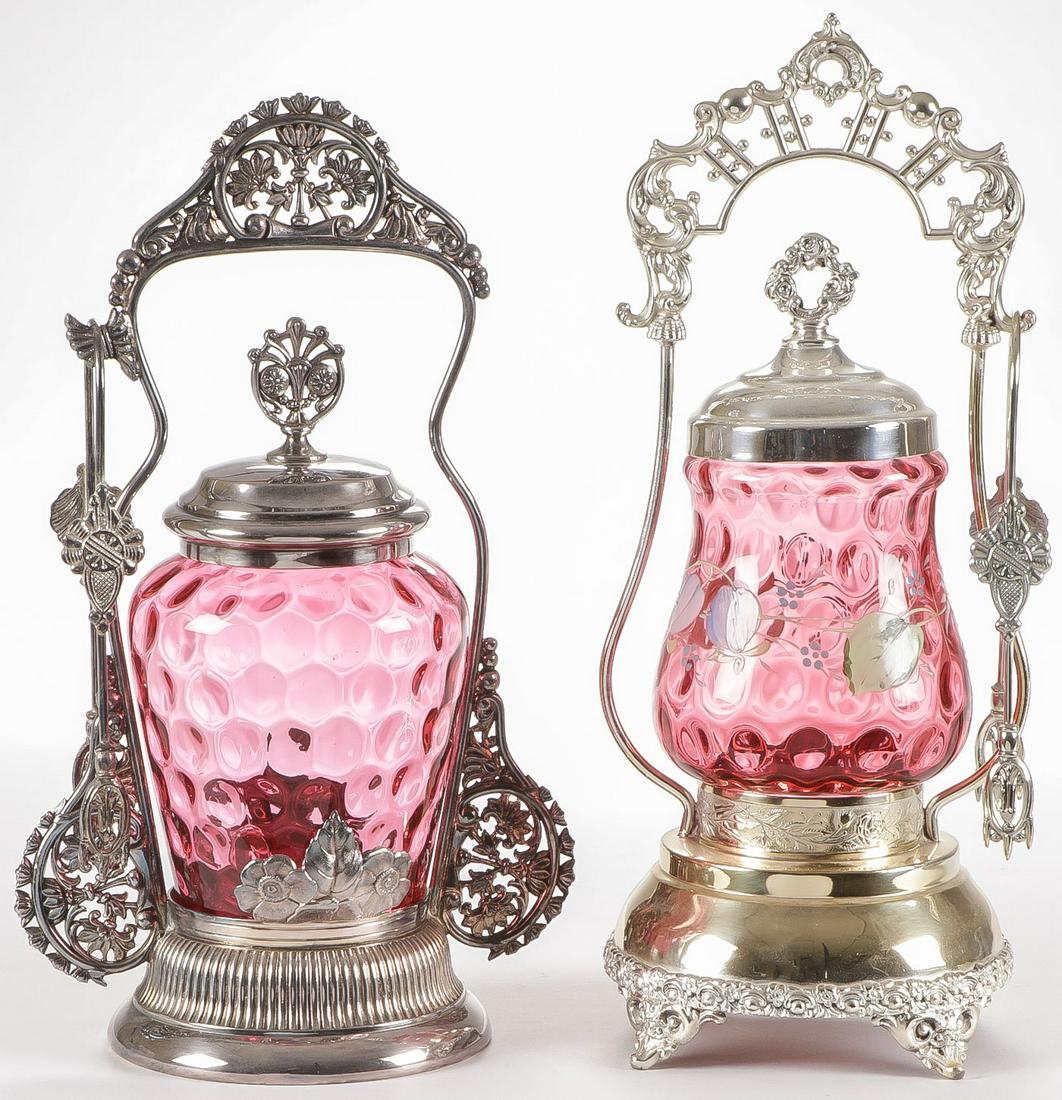 PAIR OF CRANBERRY VICTORIAN PICKLE CASTORS: PAIR OF CRANBERRY VICTORIAN PICKLE CASTORS. Both in thumbprint pattern and both in ornate silver-plated frames. Greatest height 12 inches. SHIPPING NOTICE: Jackson's is your sole and only source for o