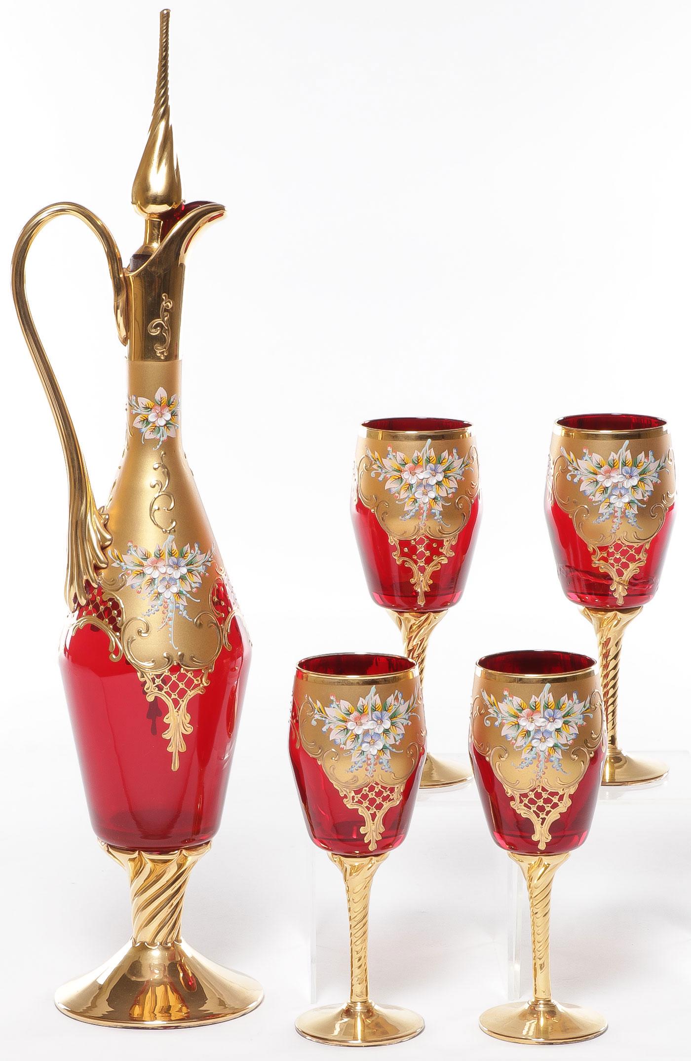 VENETIAN GOLD AND RUBY GLASS LIQUOR SET: VENETIAN GOLD AND RUBY GLASS LIQUOR SET. Comprising a decanter with fitted stopper and four stemmed glasses, heavily gilded and heavily enameled. Cracked handle on decanter. Overall height 19.25 inche