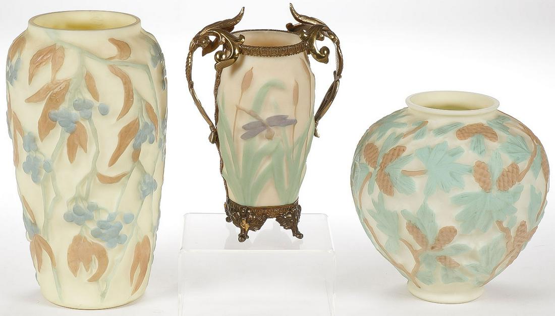 CONSOLIDATED GLASS VASES: CONSOLIDATED GLASS VASES. Comprising three individual vases including one with plums, a cattail and dragonfly decorated vase in ormolu frame and a pinecone decorated vase. Greatest height 9.5 inches.S