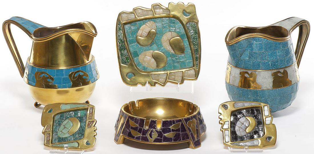 SALVADOR TERAN MOSAIC WARES: SALVADOR TERAN MOSAIC WARES. Comprising five individual pieces including two footed brass and mosaic pitchers, three mosaic trays with sculpted edges and a footed ashtray. Greatest height 7.5 inches. 