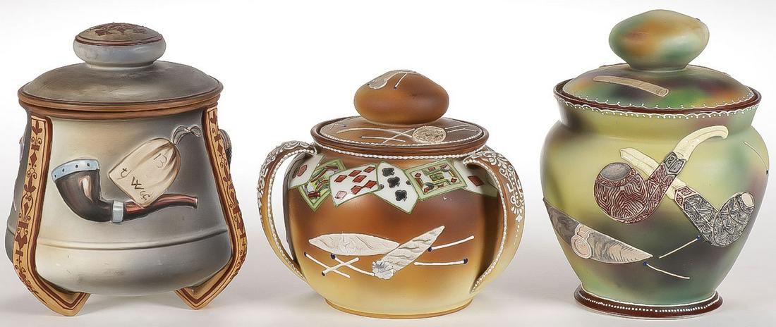 THREE NIPPON PORCELAIN HUMIDORS: THREE NIPPON PORCELAIN HUMIDORS. Each with applied raised decoration as shown. One green mark, two blue marks. Greatest height 7 inches. SHIPPING NOTICE: Jackson's is your sole and only source for one