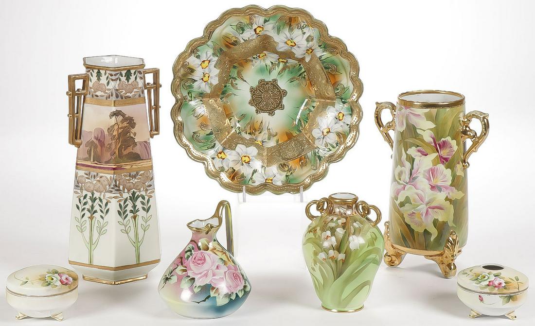 SEVEN PIECES OF GILT DECORATED NIPPON: SEVEN PIECES OF GILT DECORATED NIPPON. Comprising seven individual pieces including a spectacular hexagonal vase with landscape scene and geometric handles, a tapered cylindrical vase painted with iri