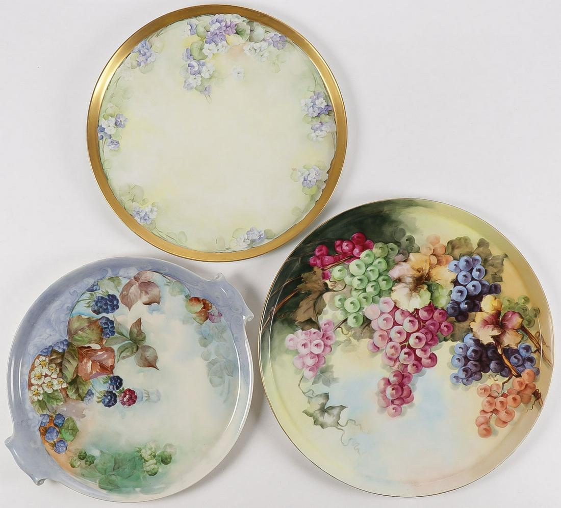 THREE LARGE HAND-PAINTED PORCELAIN PLATTERS: THREE LARGE HAND-PAINTED PORCELAIN PLATTERS. Comprising a large and impressive T&V Limoges marked platter hand-painted with grapes, diameter 18 inches, a Lenox Belleek platter with handles painted wit