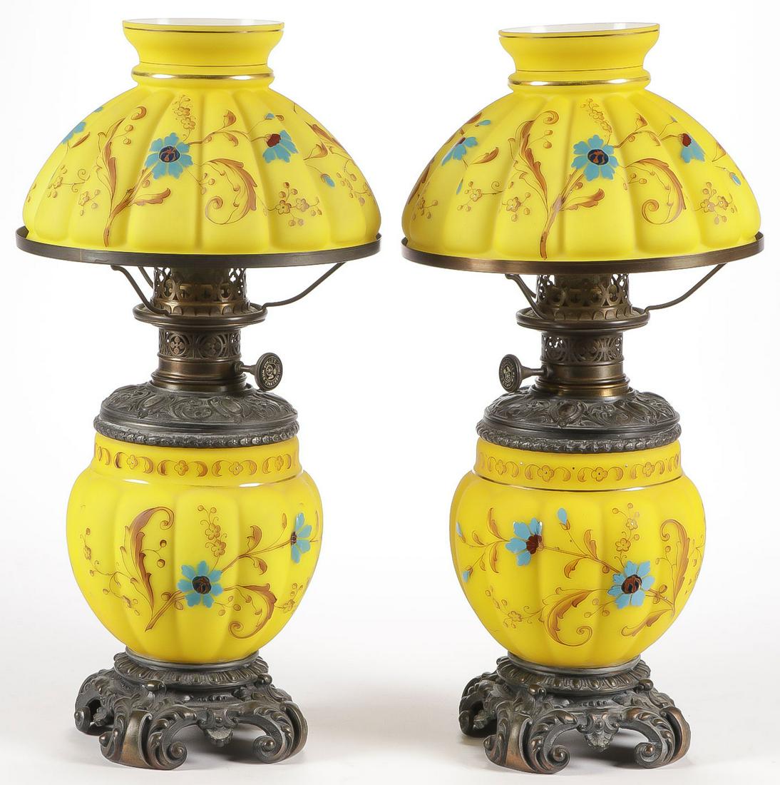 FINE PAIR OF DITMAR OIL LAMPS, C. 1890: FINE PAIR OF DITMAR OIL LAMPS, C. 1890. Comprising a matching pair of R. Ditmar oil lamps with melon shaped bases and melon ribbed mushroom shades in yellow satin glass with hand enameled florals and 