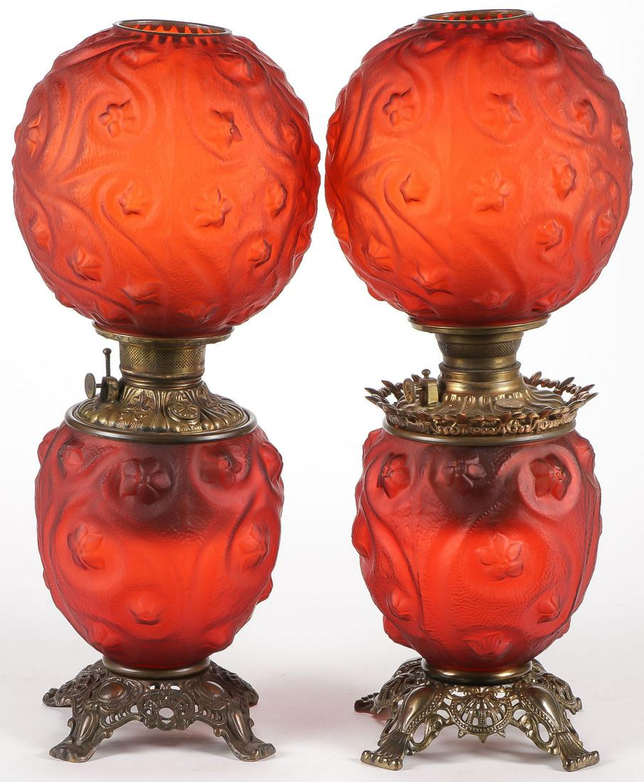 PAIR OF FOSTORIA GLASS PARLOR LAMPS: PAIR OF FOSTORIA GLASS PARLOR LAMPS. Each in red stain Shooting Star pattern and neither electrified. Height 22.75 inches.SHIPPING NOTICE:Jackson's is your sole and only source for one stop packing