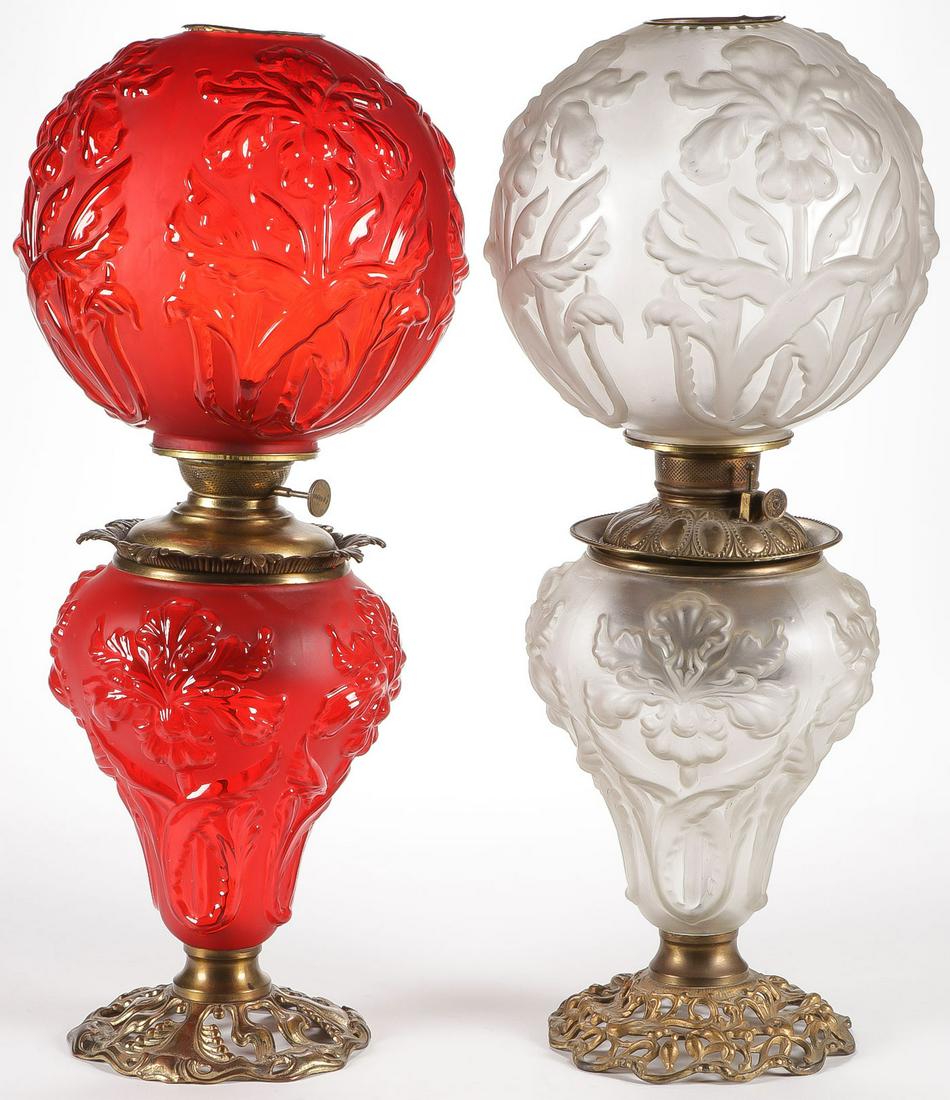 PAIR OF PITTSBURGH GWTW PARLOR LAMPS: PAIR OF PITTSBURGH GWTW PARLOR LAMPS. Each in Regal Iris pattern, one in red satin glass with polished highlights, the other in clear satin glass. Each with original font and burner, and each measurin