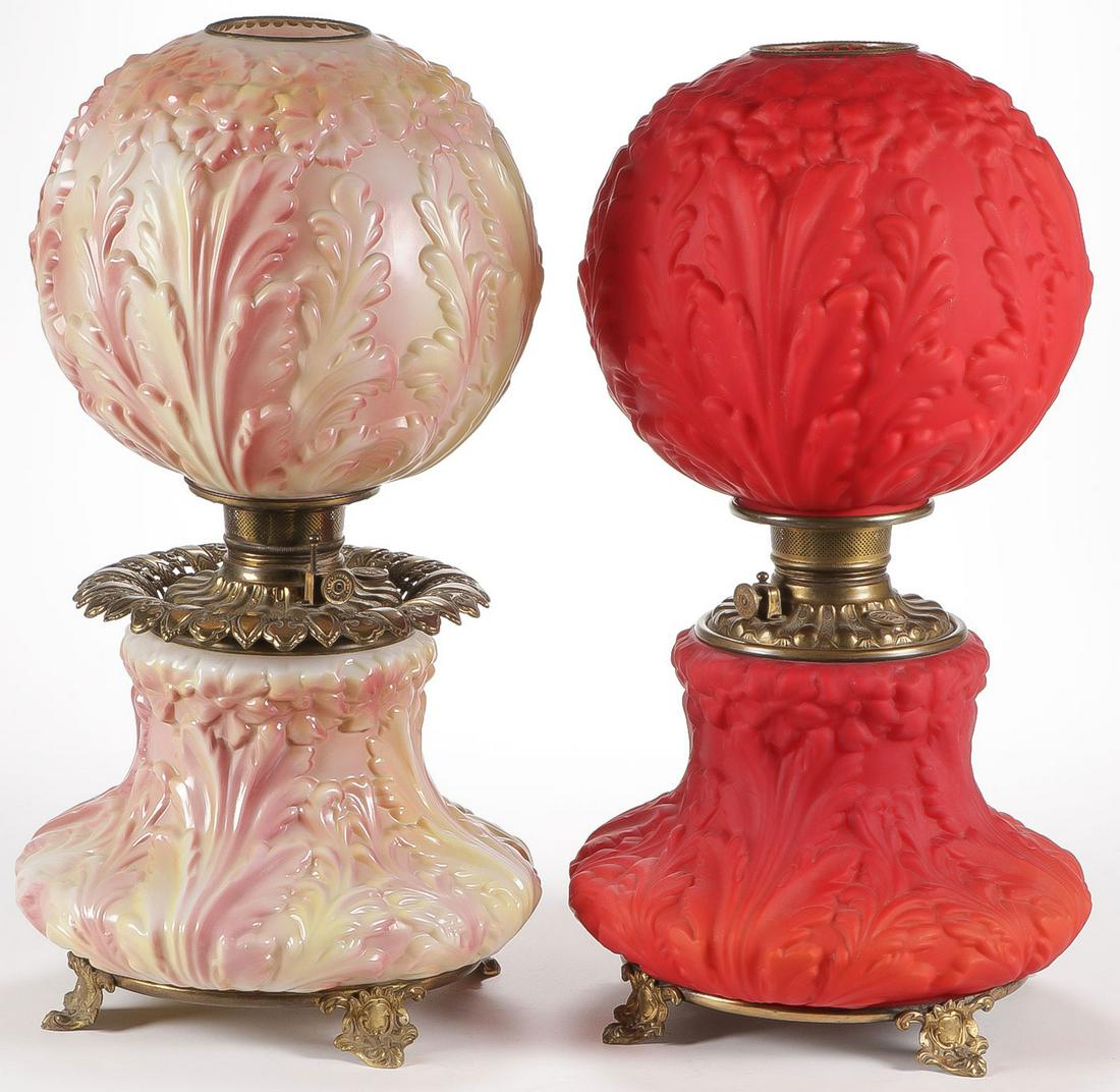 PAIR CONSOLIDATED PARLOR LAMPS, C. 1910: PAIR CONSOLIDATED PARLOR LAMPS, C. 1910. Both in primrose pattern, one in red satin glass, the other in opal tinted glass, both with fonts and burners. Height 21.5 inches. SHIPPING NOTICE: Jackson's i