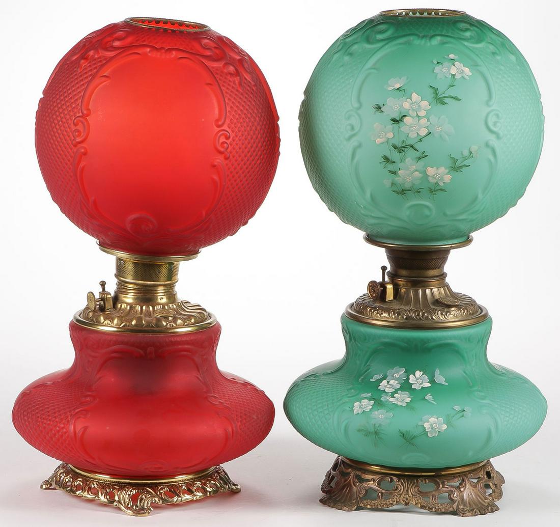 PAIR CONSOLIDATED PARLOR LAMPS: PAIR CONSOLIDATED PARLOR LAMPS. Each in Cartouche or Fishnet satin finish, one in turquoise with hand enameled flowers, and the other red. Height 20.5 inches. SHIPPING NOTICE: Jackson's is your sole a