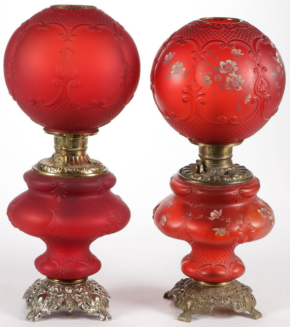 PAIR CONSOLIDATED VICTORIAN LAMPS: PAIR CONSOLIDATED VICTORIAN LAMPS. Both in Oxford red stain glass pattern, one with the addition of hand enameling, and also electrified. Average height approximately 23 inches.SHIPPING NOTICE:Jacks