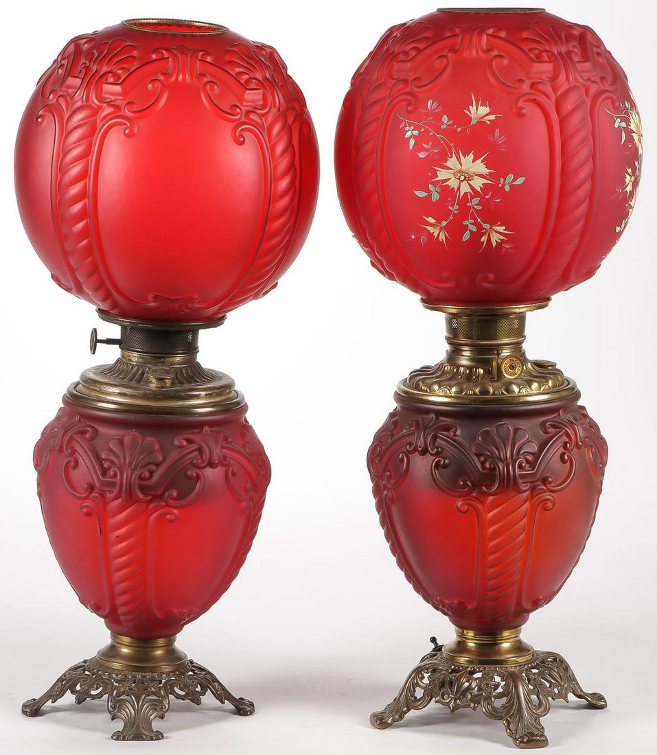 PAIR OF VICTORIAN GLASS PARLOR LAMPS: PAIR OF VICTORIAN GLASS PARLOR LAMPS. Both in red satin finish, in Twisted Cable pattern. One with hand enameled flowers (electrified). Height of each 23.5 inches. SHIPPING NOTICE: Jackson's is your s