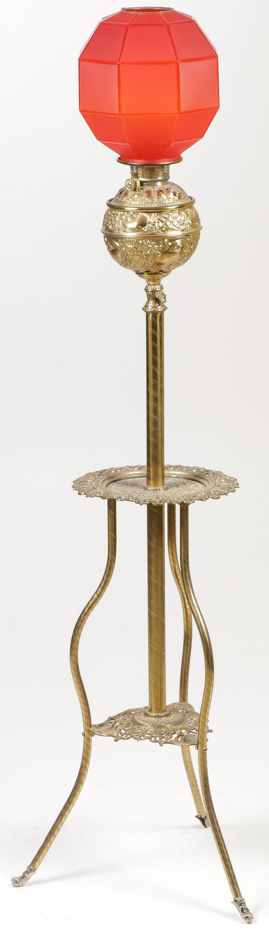 ORNATE VICTORIAN ORGAN LAMP: ORNATE VICTORIAN ORGAN LAMP. The adjustable brass base with two pierced shelves and the font with red satin glass hexagonal shade. SHIPPING NOTICE: Jackson's is your sole and only source for one stop