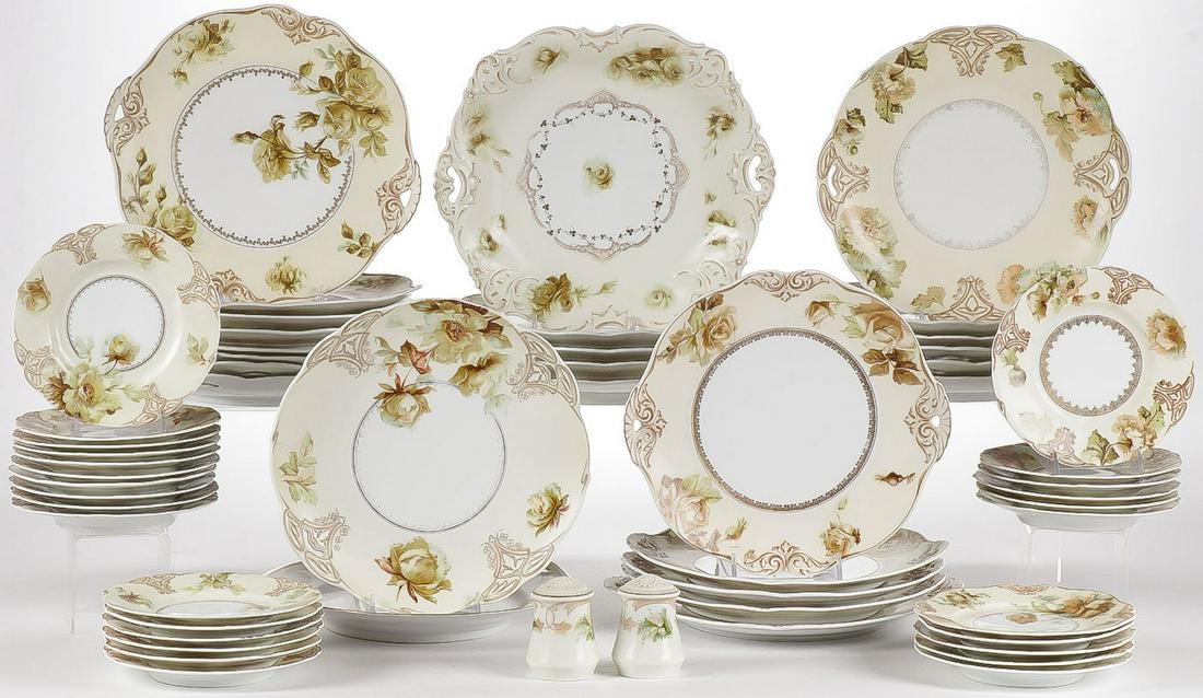 55 PIECES OF OLD IVORY PORCELAIN: 55 PIECES OF OLD IVORY PORCELAIN. Comprising 26 dinner plates, 27 saucers, salt and pepper as shown, with slight pattern variations. Greatest measurement 11 inches. SHIPPING NOTICE: Jackson's is your