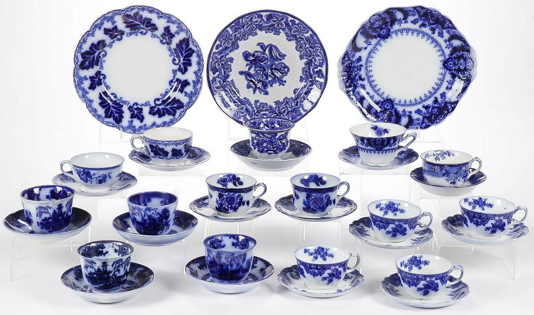 33 PIECES FLOW BLUE CUPS & SAUCERS: 33 PIECES FLOW BLUE CUPS & SAUCERS. Comprising 33 individual pieces including 12 matching pairs of tea or coffee cups and saucers, along with three matching trios (saucer, cup, and plate), including e