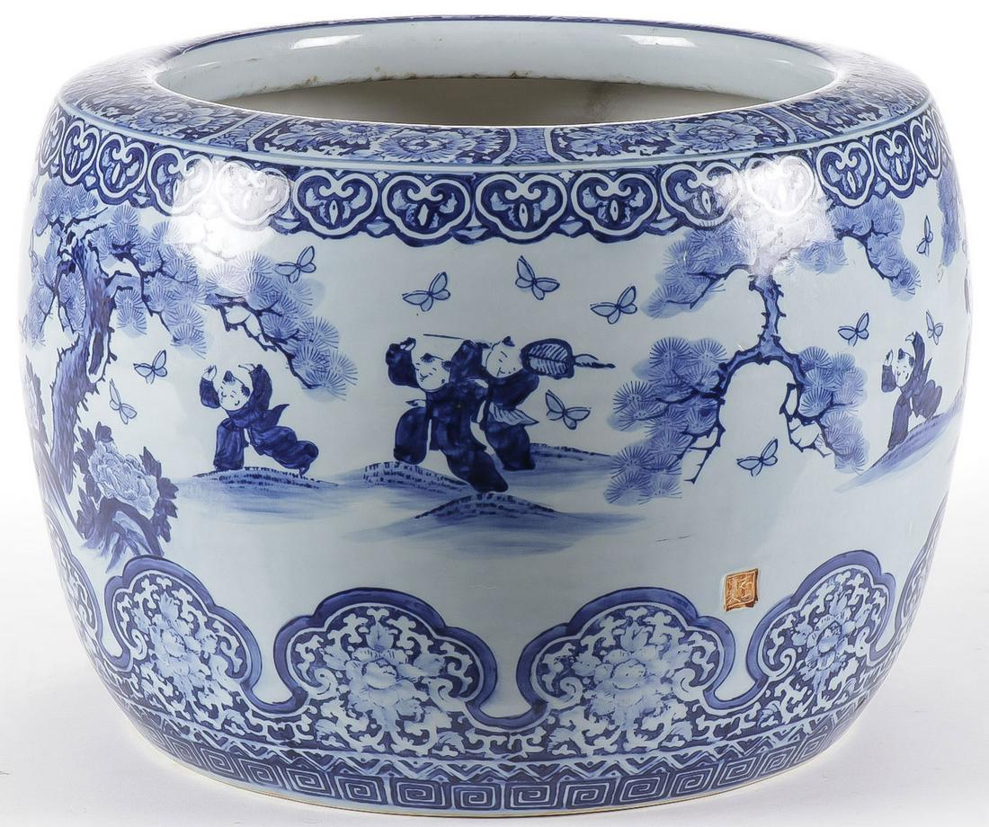 LARGE CHINESE JARDINIÈRE: LARGE CHINESE JARDINIÈRE. Blue and white glazed scenes of children chasing butterflies, impressed mark on side. Height 17 inches, diameter 18 inches. SHIPPING NOTICE: Jackson's is your sole and o