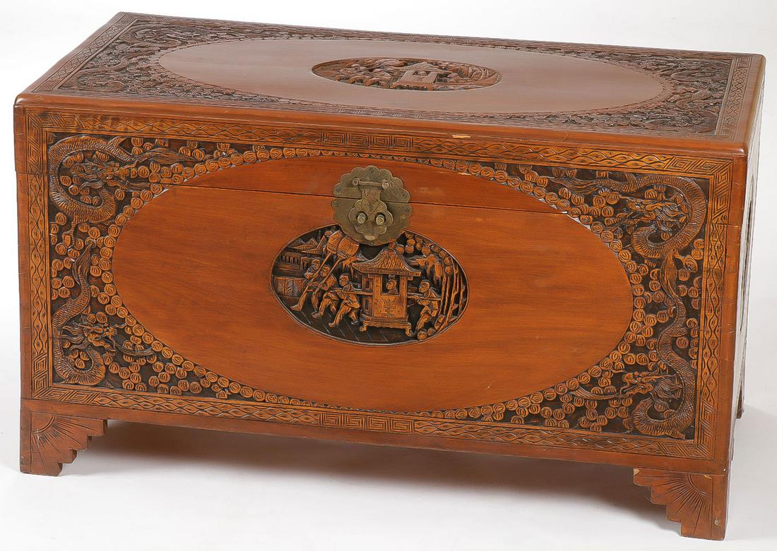 A CHINESE CARVED CAMPHOR WOOD CHEST: A CHINESE CARVED CAMPHOR WOOD CHEST. Finely carved on all sides including hinged lid and with brass decorative latch. Height 23.25 inches, depth 20 inches, length 41 inches. SHIPPING NOTICE: Jackson's