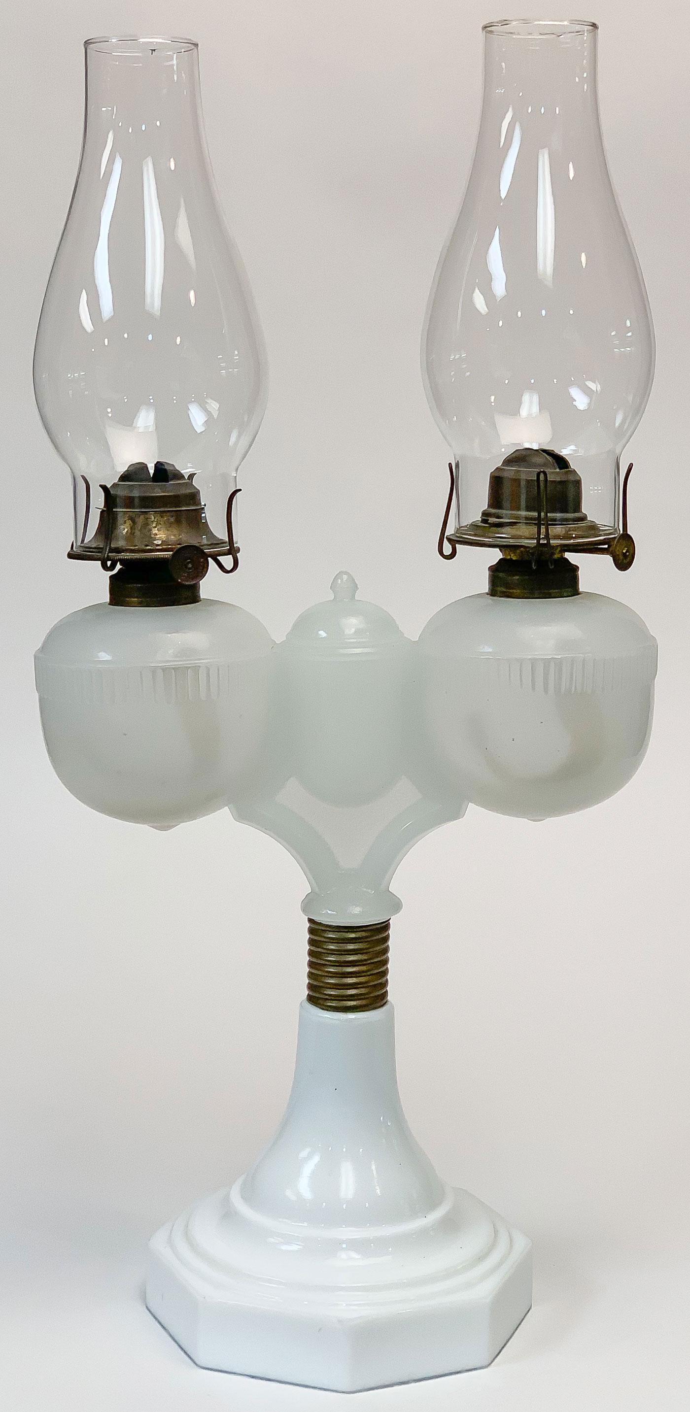 SCARCE DOUBLE WEDDING LAMP: SCARCE DOUBLE WEDDING LAMP. Resting on a milk glass octagonal base with cone stem and threaded screw on brass ribbed collar. Supporting an opaque glass double oil font with the original match holder a