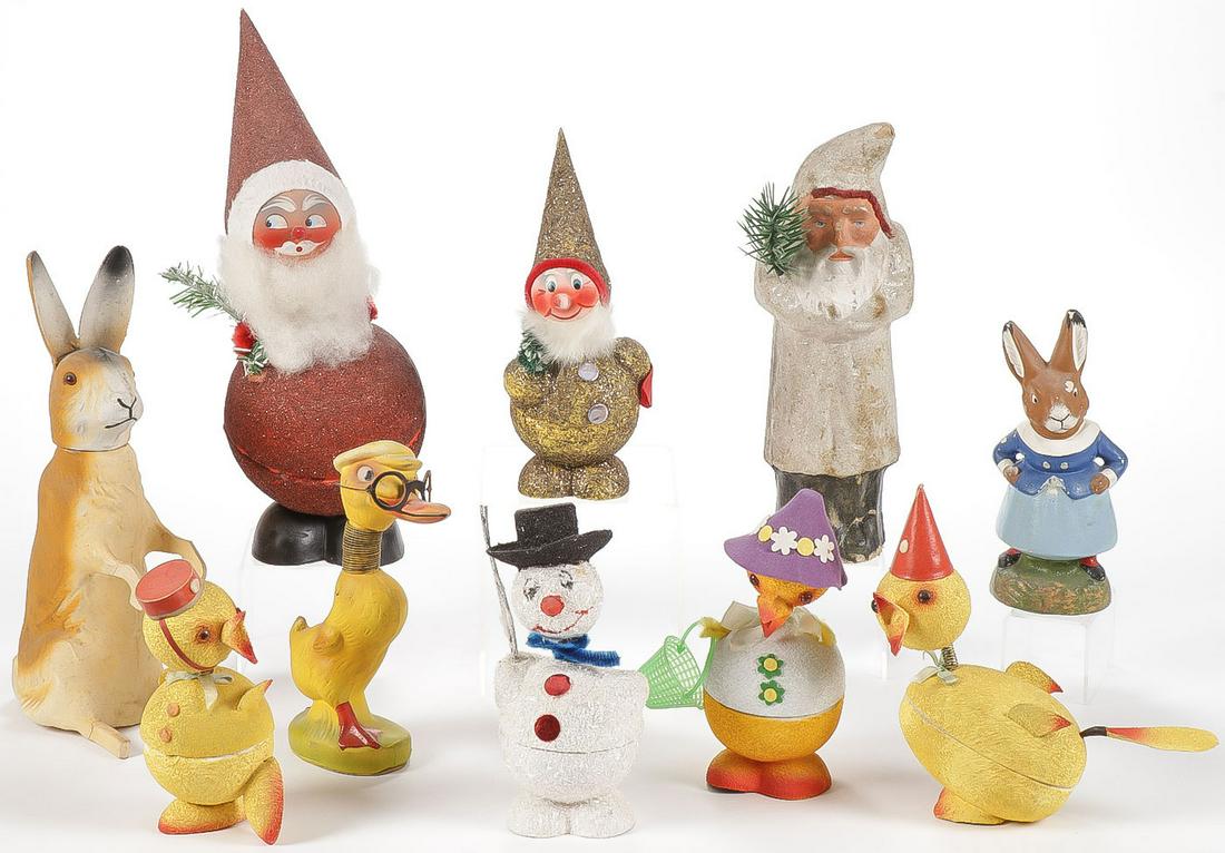 10 GERMAN HOLIDAY DECORATIONS: 10 GERMAN HOLIDAY DECORATIONS. Comprising ten paper and paper mâché holiday decorations circa 1900-1955. Including Santas, bunnies, snowmen and Easter chicks with spring heads and coralene d
