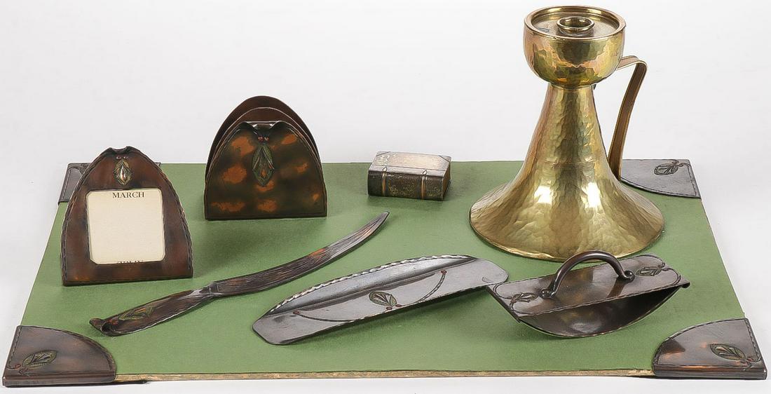 ARTS AND CRAFTS COPPER DESK SET & MORE: ARTS AND CRAFTS COPPER DESK SET & MORE. Comprising a nine-piece hammered and chased copper desk set including four corners, a pen tray, letter opener, calendar, letter holder and blotter. As well as a